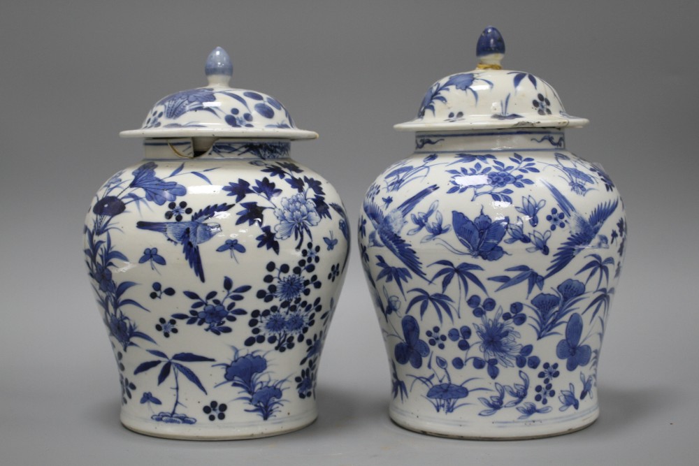A pair of 19th century Chinese blue and white vases and covers, decorated with birds and flowers, height 23cm